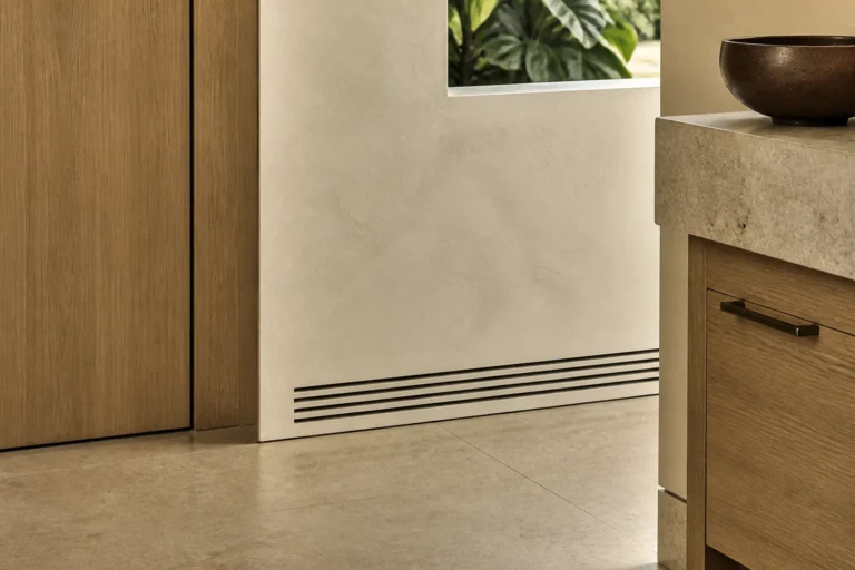Architectural close-up of moisture-aware luxury materials, stone, wood and discreet ventilation in a Florida interior